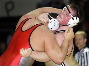 Perrysburg’s Cale Bonner, right, battles Fremont St. Joseph’s Corey Durbin at 285 pounds. Bonner (21-2), a junior, was eighth at state last year.