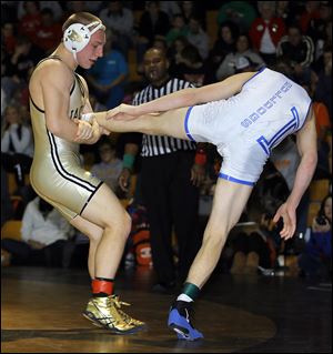 Perrysburg senior J.P. Newton, left, works to take down Defiance’s Robbie Bowers in the 152-pound final of the Perrysburg Invitational Tournament. Newton (20-3), who will wrestle at Ohio State, placed third at state last year.