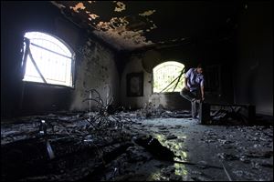 A Libyan man investigating the inside of the  U.S. Consulate in Benghazi, Libya, after an attack that killed four Americans, including Ambassador Chris Stevens, in September, 2012.