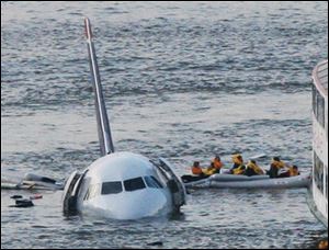 Jan. 15, 2009, passengers in an inflatable raft move away from US Airways Flight 1549 that went down in the Hudson River in New York. Capt. 