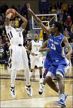 University of Toledo guard Julius Brown (20) hits the game winning shot against Buffalo forward Xavier Ford (35) today.