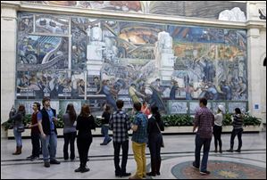 Visitors look at the Detroit Industry Murals by the Diego Rivera at the Detroit Institute of Arts in Detroit.