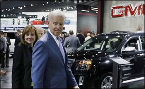 Vice President Joe Biden and Mary Barra, General Motors’ chief executive officer, look over the GM display during a tour of the North American International Auto Show in Detroit.