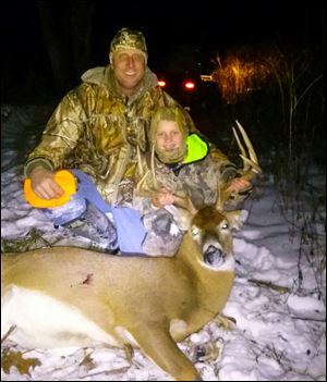 Braden Curry, 8, and his dad, Steve, pose with Braden’s first deer: A 10-pointer he shot with a muzzleloader in Licking County.