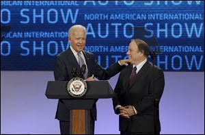 Vice President Joe Biden talks with Detroit Mayor Mike Duggan before touring the North American International Auto in Detroit early today.