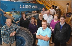 Owners Robert Boos, left, and Charles Boos, center, join several of their employees at the headquarters of A.A. Boos & Sons. The company says it will pass on a risky project so that it can keep its workers safe.
