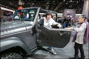 Gloria Wise of Troy, Mich., steps out of a 2014 Jeep Wrangler Willys Wheeler at the show. She was joined by her mother, Jo Dunphy of Yellow Springs, Ohio. 