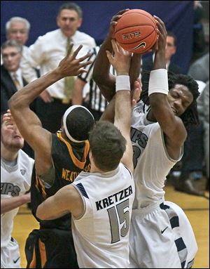 J.D. Weatherspoon battles Jake Kretzer (15) of Akron and Quincy Diggs. Weatherspoon had a career-high 20 points and 14 rebounds.