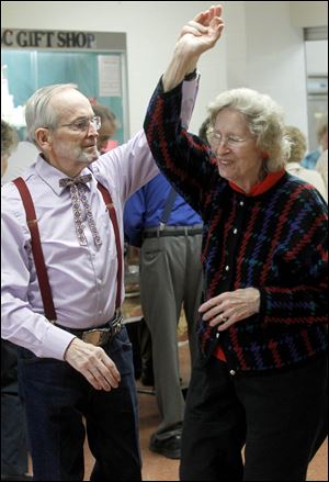 Fred Miller and his wife Remona Miller, from Sylvania, take a spin on the dance floor during a Happy Feet Dancers event, which is open to the public.