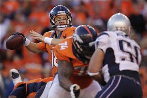 Broncos quarterback Peyton Manning threw for 400 yards and two touchdowns Sunday to lead Denver to its first trip to the NFL title game in 15 years. The Broncos beat the New England Patriots 26-16.