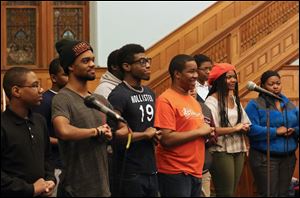 Toledo Youth Choir members laugh as they set up to sing during practice.