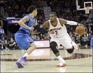 Cleveland Cavaliers' Kyrie Irving drives past Dallas Mavericks' Shane Larkin during the second quarter Monday in Cleveland.