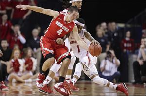 Ohio State guard and Liberty-Benton graduate Aaron Craft (4) steals the ball from Nebraska's Deverell Biggs (1) in the first half Monday in Lincoln, Neb.