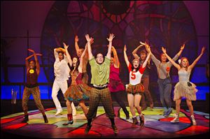 Cast members of ‘Godspell’ dance and sing during a performance.
