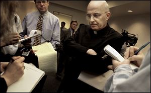 Chicago Cardinal Francis George listens to reporters' questions before he left for Rome to meet with Vatican officials and other American cardinals about the child sex abuse scandals in the United States in April, 2002.