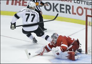 Detroit Red Wings goalie Jimmy Howard (35) stops a shot by Los Angeles Kings center Jeff Carter (77) during the shootout period of an NHL hockey game in Detroit, Saturday.