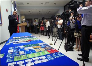 McAllen Police Chief Victor Rodriguez talks to media next to a dozens of fraudulent credit cards that were confiscated by McAllen police after arresting a man and a woman on fraud charges tied to the December Target credit card breach, Monday at the McAllen Police Department in McAllen, Texas.