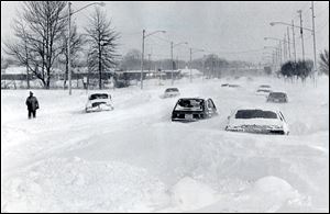 Cars were virtually buried on Heatherdowns Boulevard after the 1978 blizzard. Local authorities restricted driving in the most recent storms, keeping the number of stranded autos to a minimum.