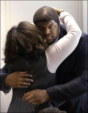 Former Dallas Cowboys NFL football player Josh Brent gets a hug from family after closing arguments in his intoxication manslaughter trial Tuesday, Jan. 21, 2014, in Dallas.