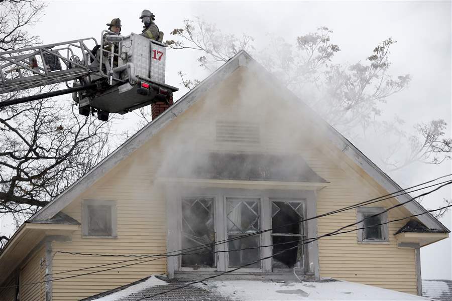 Fireman-on-the-scene-of-a-house-fire-on-Cottage-Street
