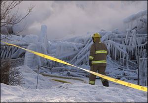 Firefighters work at the scene of a senior's residence fire today in L'Isle-Verte, Quebec.  