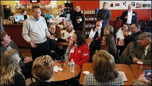 Ohio Governor John Kasich talks with supporters Thursday at Coffee Amici in Findlay.