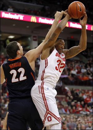 Ohio State's Lenzelle Smith Jr., right, grabs a rebound against Illinois' Maverick Morgan during the first half Thursday in Columbus.