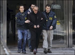 FBI agents flank Vincent Asaro as they escort the reputed mobster from FBI offices in lower Manhattan, Thursday in New York. More than 30 years after the crime, Asaro was indicted in the $6 million Lufthansa heist at Kennedy Airport that was dramatized in the Martin Scorsese movie 