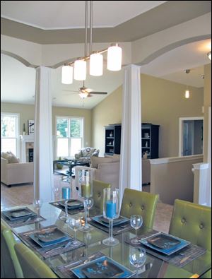 The dining room’s tapered pillars and arches are just a few of the details you will find in a Josh Doyle home.