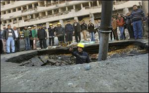 An Egyptian firefighter checks a crater made by a blast at the Egyptian police headquarters in downtown Cairo.
