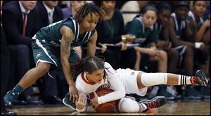 Bowling Green State University guard Jillian Halfhill (11) battles Eastern Michigan guard Cha Sweeney (24) for a loose ball, Thursday at the Stroh Center.