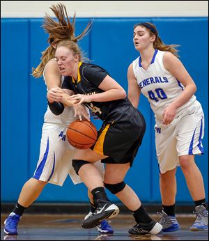 Anthony Wayne's Lindsey Hood, left, knocks the ball away as she guards Northiew’s Maddie Cole.  Northview is 13-4.