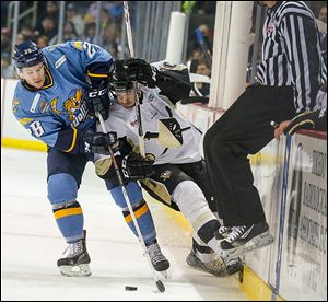 Toledo ’s Bobby Shea, left, battles Wheeling’s Jacob Lagace for control of the puck during the first period on Friday.