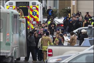 Mall shoppers are loaded onto shuttle busses and evacuated by police and rescue personnel.