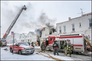 Toledo firefighters battle the blaze at 528 Magnolia, a six-unit apartment building in North Toledo. Two firefighters died from injuries while fighting the blaze that was reported Sunday afternoon.