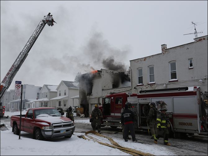CTY fire27p Toledo firefighters battle a blaze at 528 Magnolia, a six unit apartment building in Toledo.  