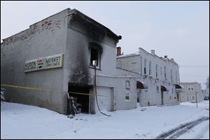 The building at 548 Huron Street, site of a fire which took the lives of two Toledo Fire Department firefighters and made seven people homeless, sits surrounded by fresh snow today.