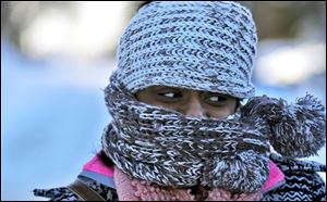 Nyjaii Williams, of St. Paul, is bundled up against the cold wind, Sunday in St. Paul, Minn.