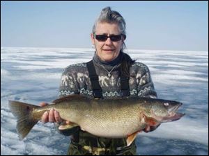 Sal Oates with a 30-inch, 11-pound walleye she caught through the ice near South Bass Island. Walleye add weight in the winter.