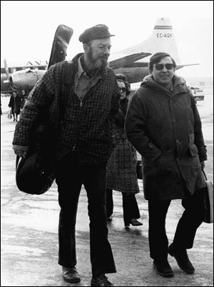 This Feb. 10, 1971, file photo shows American Folk singer Pete Seeger, left, with Spanish singer Raymond, at Madrid's Barajas airport enroute to a concert in the southern Spanish city of Seville.  