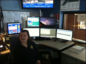 Morgan Donnell, a dispatcher for Perrysburg Township, explains the new software that will provide township police officers with more information and more quickly on each emergency call. 