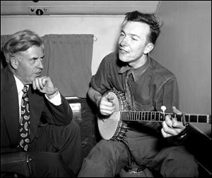 Henry A. Wallace,listens to Pete Seeger  on a plane between Norfolk and Richmond, Va., in 1948.