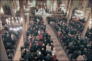 Nearly 1,000 local and retired firefighters and their families gather for Mass at the Historic Church of St. Patrick in honor of Toledo firefighters Stephen Machcinski and James Dickman, who died on duty Sunday.