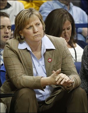 UT coach Tricia Cullop wears a firefighter pin during the game against Akron. The players and coaches wore the pins in memorial of the city’s fallen firefighters.
