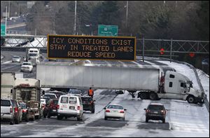 A truck blocks all east-bound lanes of   Interstate 285 in Sandy Spring, Ga. after hitting a patch of ice.