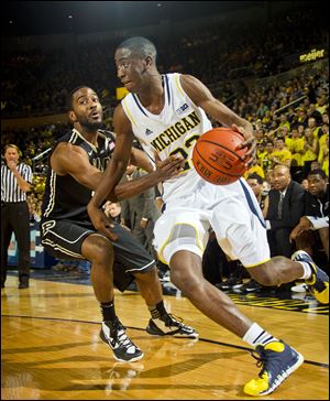 Purdue guard Rapheal Davis, left, defends Michigan guard Caris LeVert, who had 14 points and a career-high 11 rebounds for his first career double-double on Thursday night.