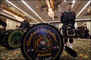 Fred Kartune with the Cleveland Firefighters Memorial Pipes & Drums waits with other national members of the pipes and drum corps before playing at the Last Alarm Service at the SeaGate Convention Centre downtown for firefighters Stephen Machcinski and James Dickman, who were killed in the line of duty Sunday in Toledo.