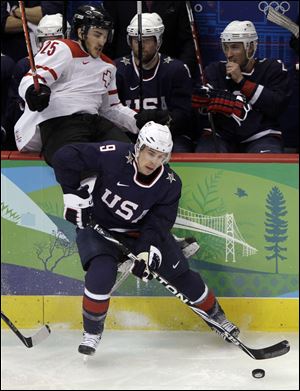 Team USA's Zach Parise (9) goes against Switzerland in the 2010 Olympics.