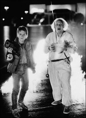Michael J. Fox as Marty McFly, left, and Christopher Lloyd as inventor Doctor Emmett Brown in a scene from the film, “Back to the Future.
