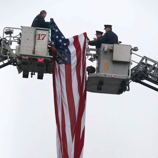 Toledo-firefighters-put-up-the-large-American-flag